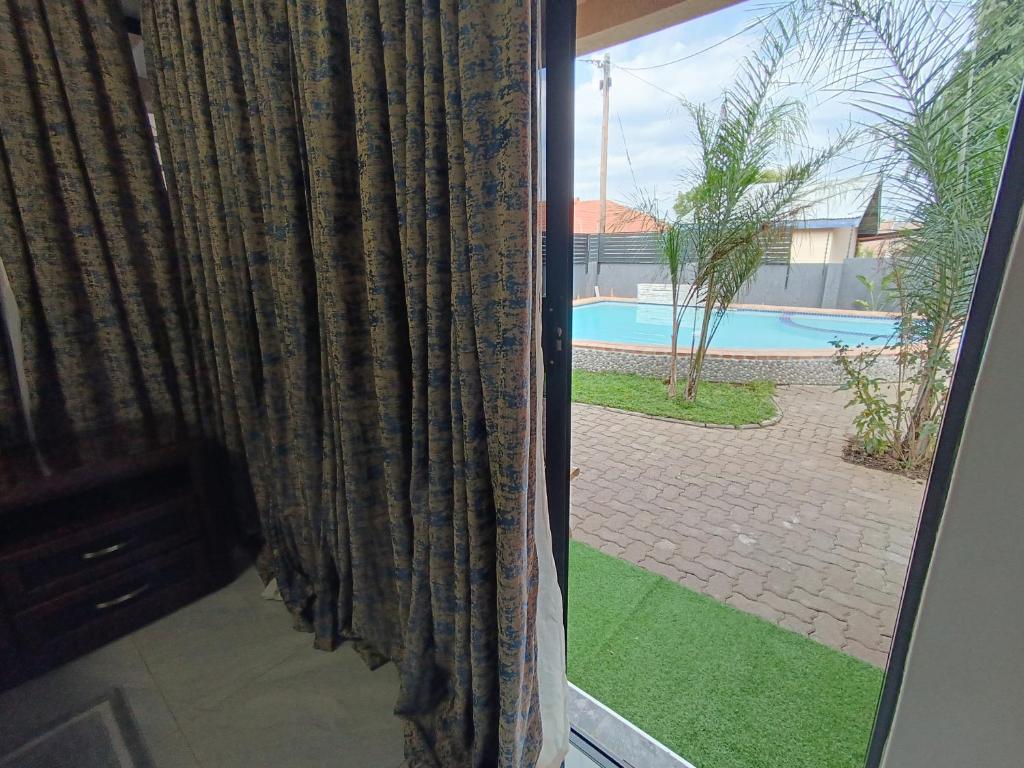 Swimming pool and garden at Manasseh Guest House